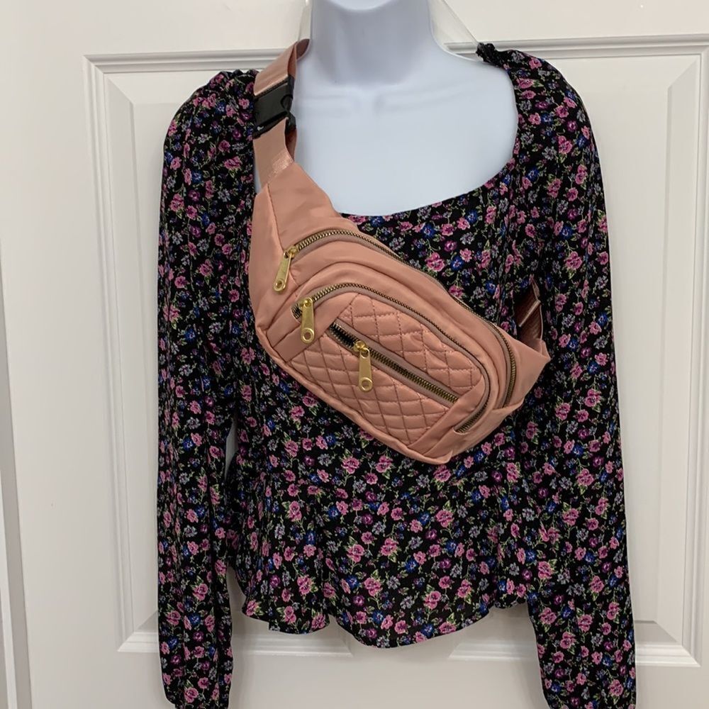 Light pink sling bag with for zipper closure pockets. NWT from local boutique.